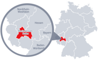 Diese Grafik zeigt eine Karte von Deutschland mit einer detaillierten Ansicht der Region Rheinhessen-Nahe. Rheinhessen-Nahe ist in Rot hervorgehoben und liegt im südwestlichen Teil Deutschlands. Ein Lupensymbol vergrößert diesen Bereich, um die Lage genauer darzustellen.