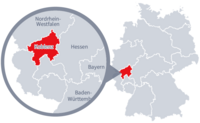 Diese Grafik zeigt eine Karte von Deutschland mit einer detaillierten Ansicht der Region Koblenz. Koblenz ist in Rot hervorgehoben und liegt im südwestlichen Teil Deutschlands. Ein Lupensymbol vergrößert diesen Bereich, um die Lage genauer darzustellen.